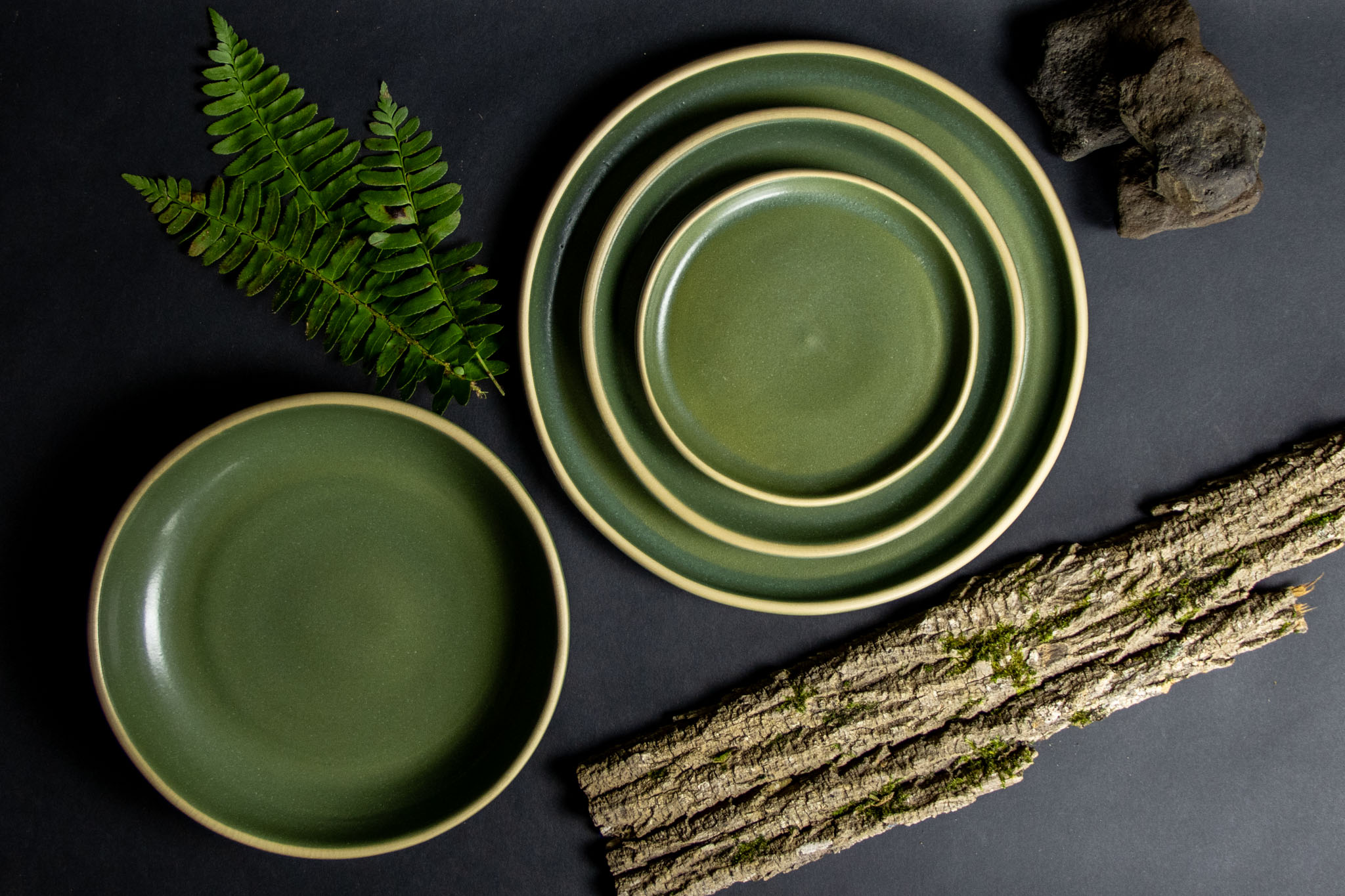2026 Handmade Pottery Summer Gift Guide 4 Moss Brookline Dinnerware Set with natural bark and ferns.