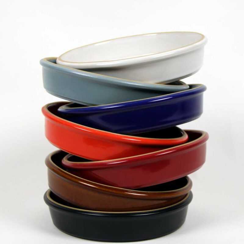 Selection of stoneware pottery Brookline Bakers in multiple glazes and hand-painted designs.